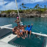 Friends having a multi-day sailing adventure along Big Island coastline.