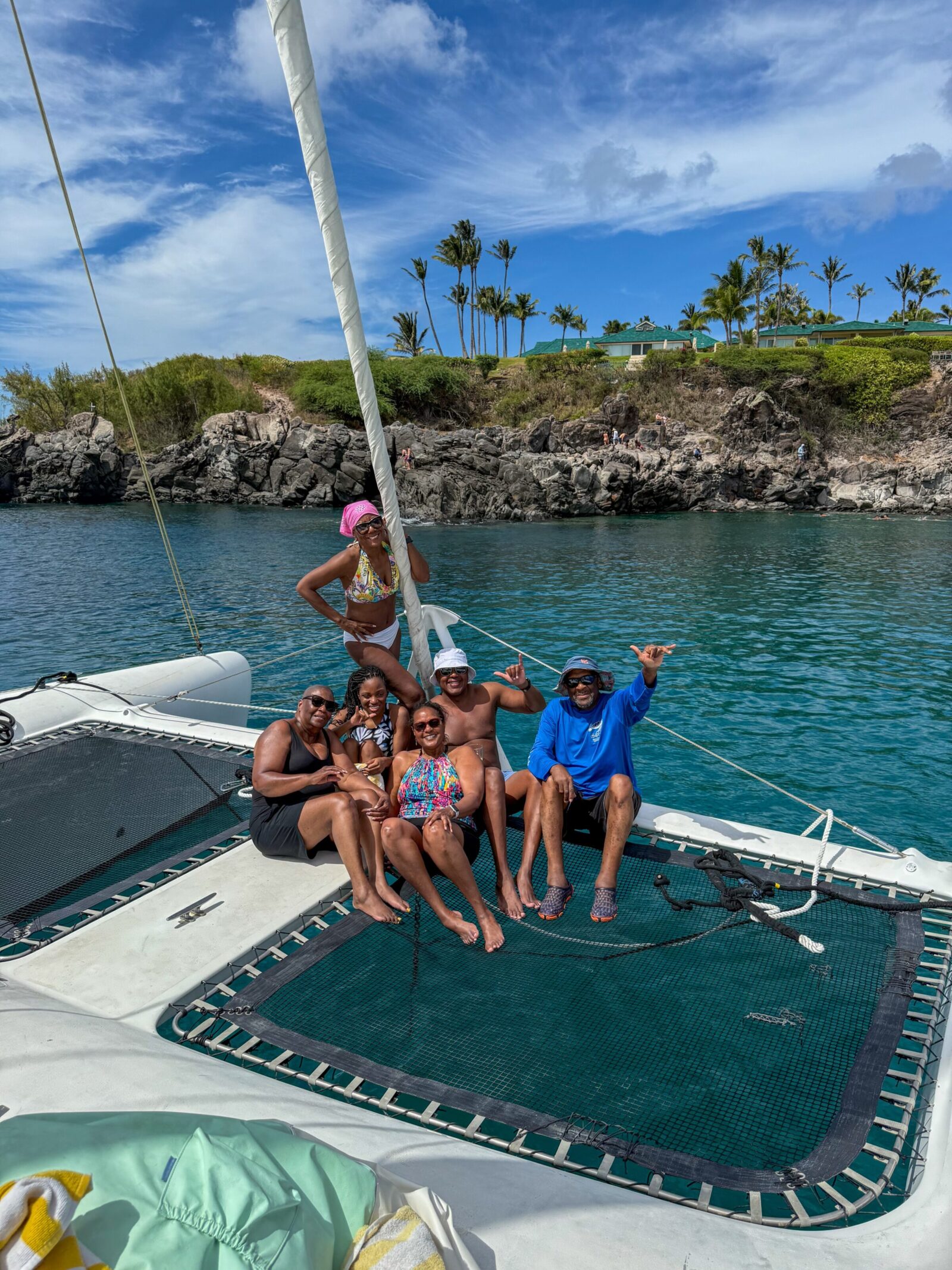 Friends having a multi-day sailing adventure along Big Island coastline.