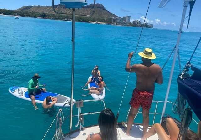 Group of friends enjoying a relaxing full-day sailing trip.