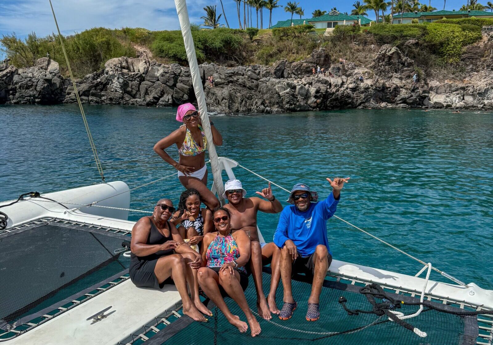 Friends having a multi-day sailing adventure along Big Island coastline.